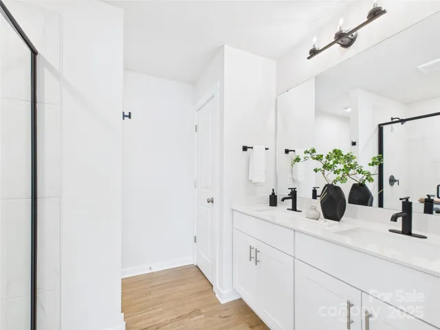 a bathroom with a double vanity sink and a mirror