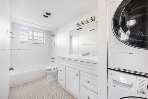 a bathroom with a toilet a sink and bathtub