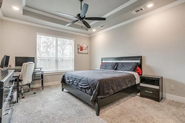 a bedroom with a bed chair and a desk