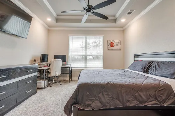a bedroom with a bed and a desk