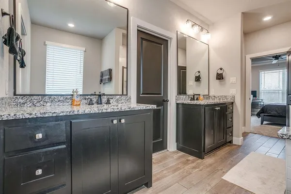 a bathroom with a sink double vanity and a mirror