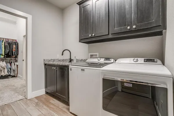 a living room with baby crib furniture and a window