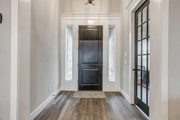 a view of a hallway with wooden floor and staircase
