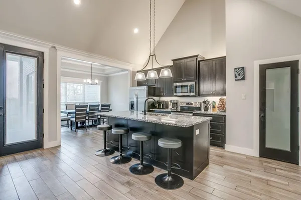 a kitchen with granite countertop a sink appliances and cabinets