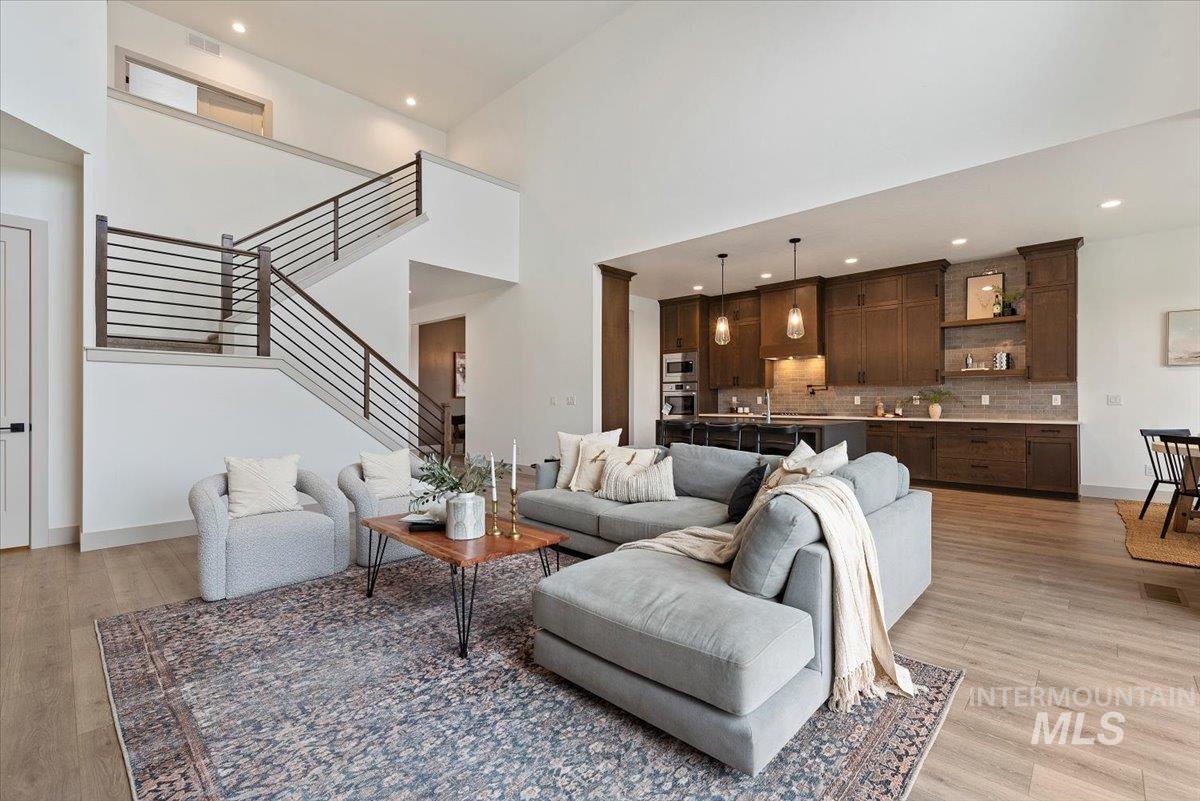 8458 West Graye Street, Unit RAINIER Meridian, ID 83646 - Photo 11 of 29 Living room with recessed lighting, light wood-style floors, and a high ceiling