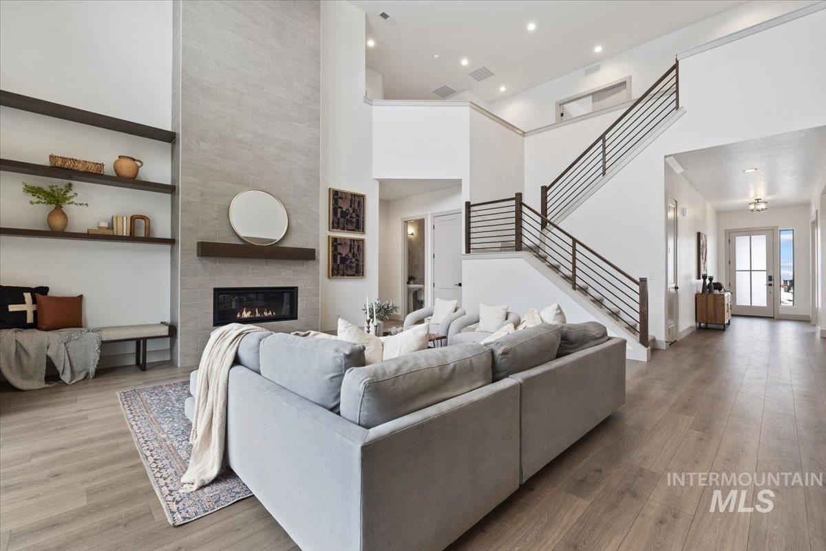 8458 West Graye Street, Unit RAINIER Meridian, ID 83646 - Photo 14 of 29 Living room with wood finished floors, a high ceiling, french doors, and a tile fireplace