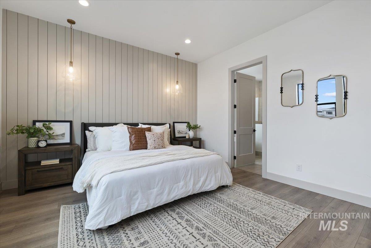 8458 West Graye Street, Unit RAINIER Meridian, ID 83646 - Photo 16 of 29 Bedroom featuring wood finished floors, an accent wall, recessed lighting, and wooden walls