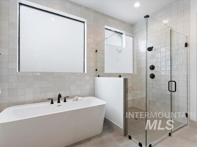 8458 West Graye Street, Unit RAINIER Meridian, ID 83646 - Photo 18 of 29 Full bathroom with tile walls, a freestanding bath, a shower stall, and recessed lighting