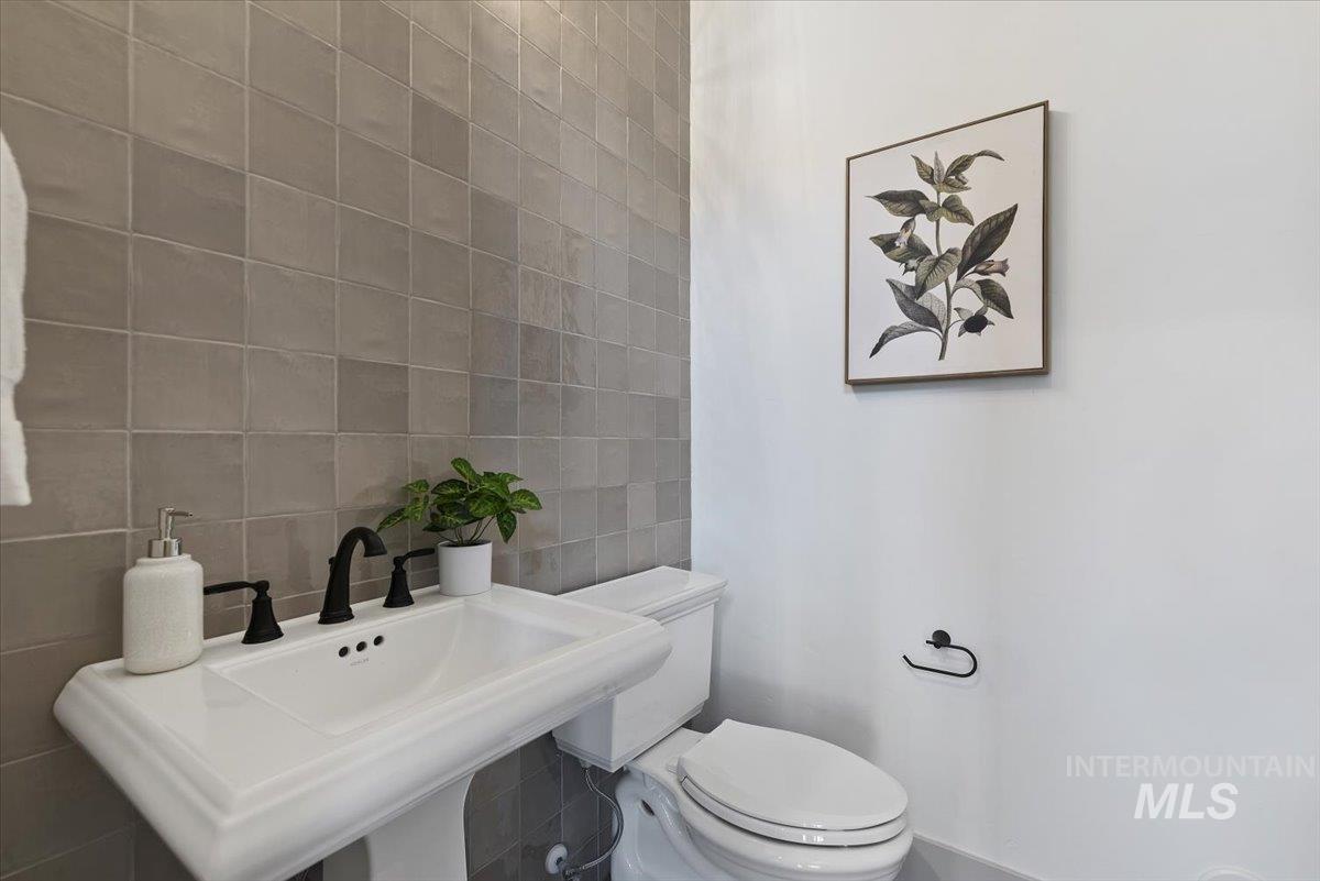 8458 West Graye Street, Unit RAINIER Meridian, ID 83646 - Photo 20 of 29 Half bath with tile walls and toilet