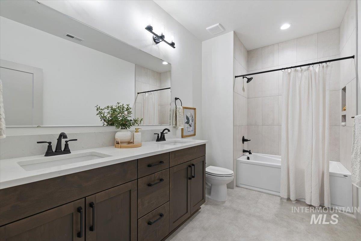 8458 West Graye Street, Unit RAINIER Meridian, ID 83646 - Photo 22 of 29 Full bath featuring double vanity, shower / tub combo with curtain, and recessed lighting