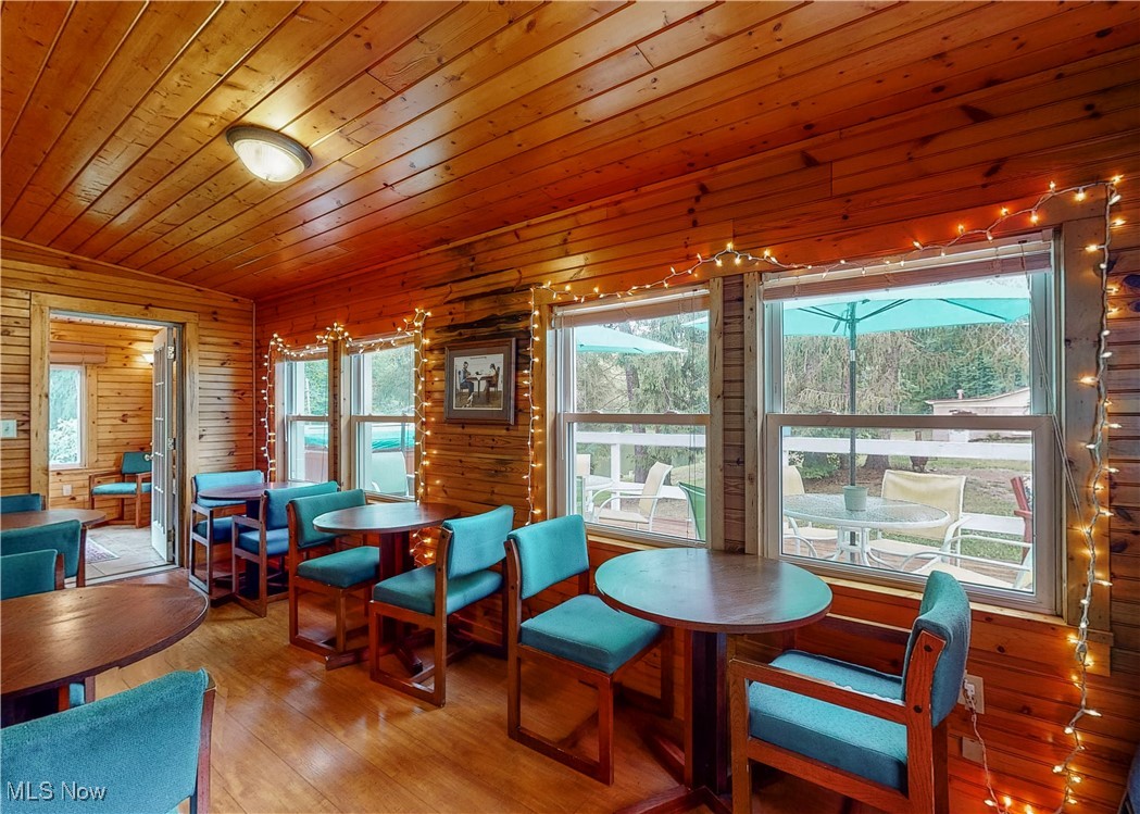 5696 Steubenville Road Southeast Amsterdam, OH 43903 - Photo 9 of 50 Sunroom featuring lofted ceiling, a wealth of natural light, and wooden ceiling