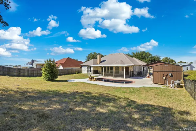 a view of a house with swimming pool and porch with furniture