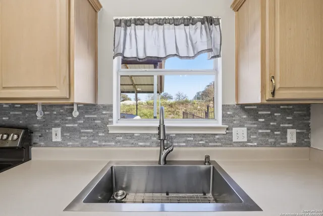 a kitchen with a sink and a window