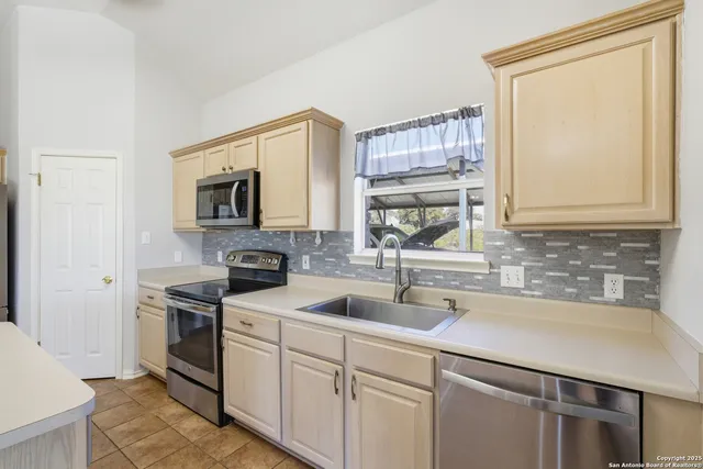 a kitchen with a sink stove and microwave