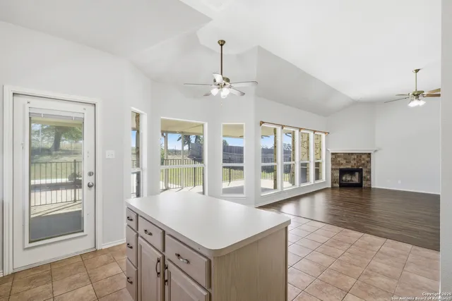 a room with pool table and windows