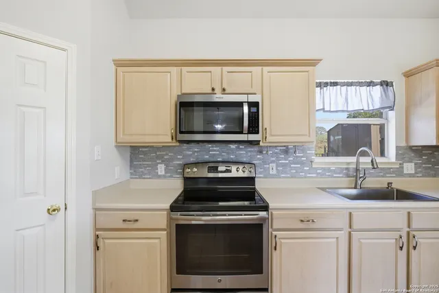 a kitchen with a stove and a microwave