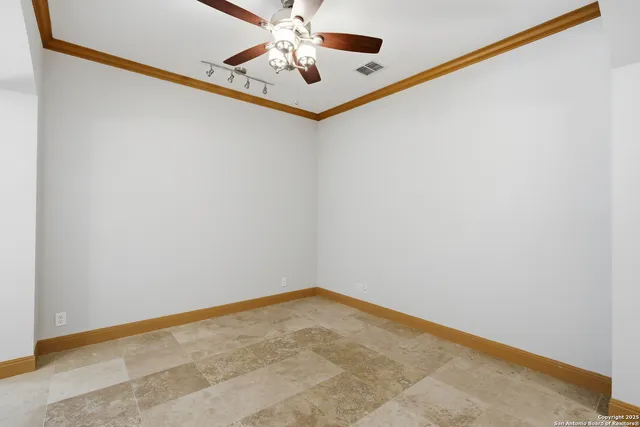 a view of a room with a ceiling fan and a window