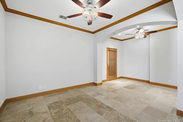 a view of a hallway with a ceiling fan