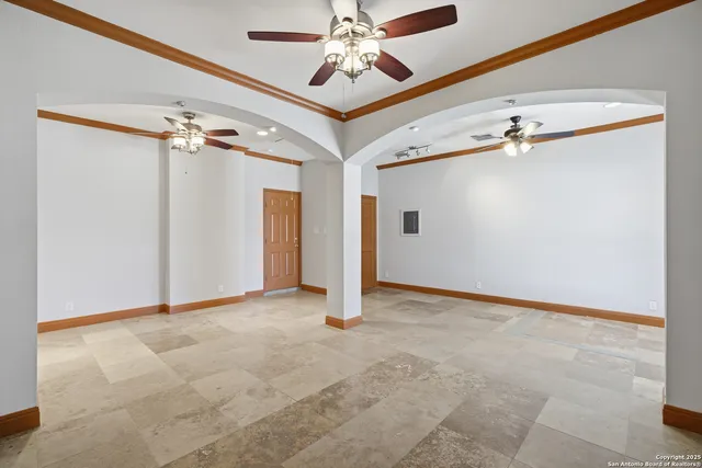 a view of an empty room with a ceiling fan