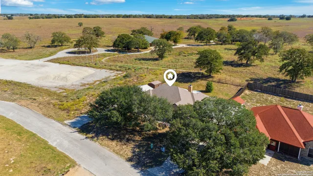 an aerial view of a house with a lake view