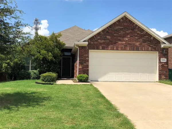 a view of a house with a yard and garage