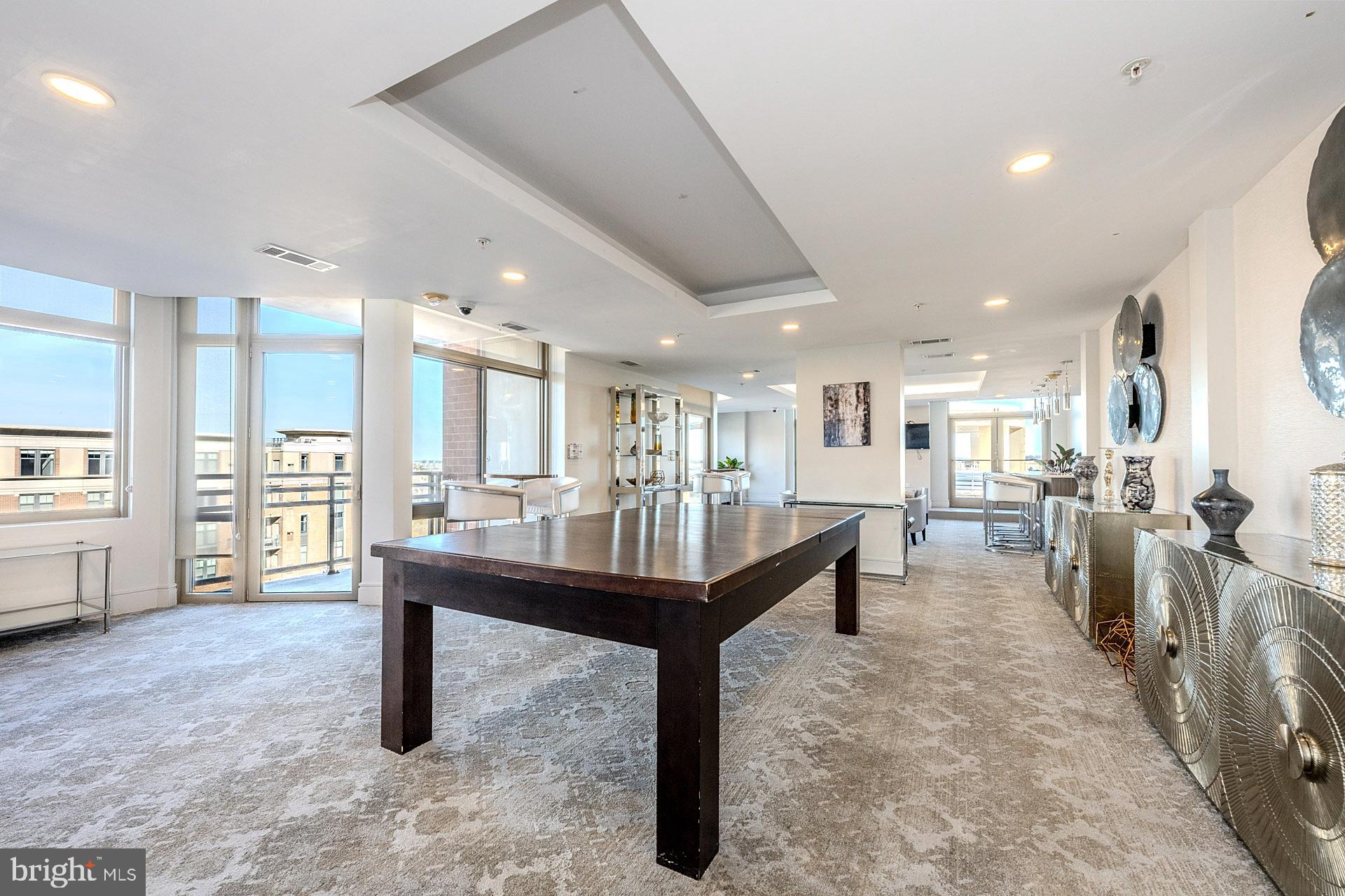 3650 South Glebe Road, Unit 460 Arlington, VA 22202 - Photo 26 of 38 a room with lots of wooden furniture and a table