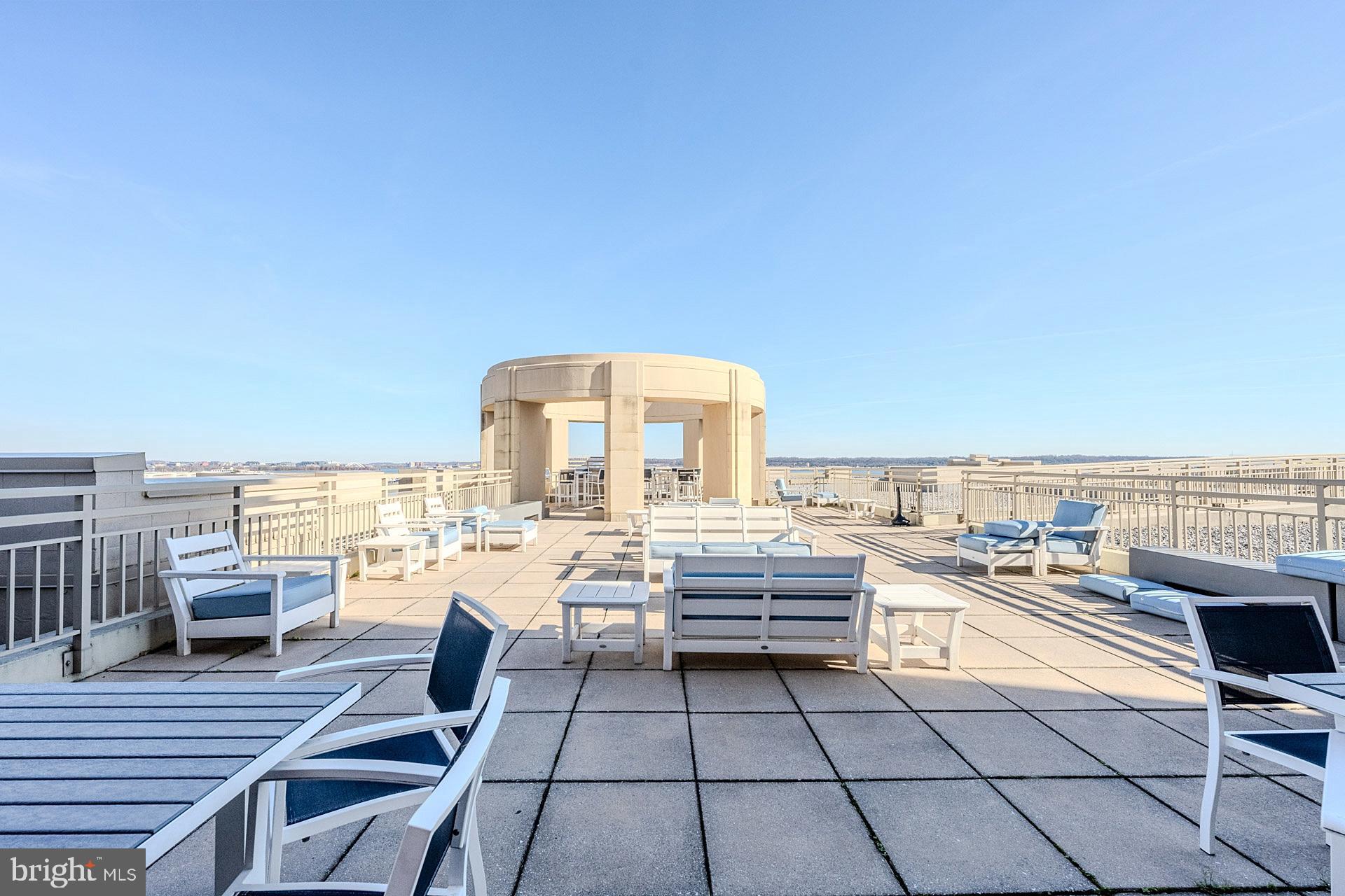 3650 South Glebe Road, Unit 460 Arlington, VA 22202 - Photo 30 of 38 a view of roof deck with dining table and chairs