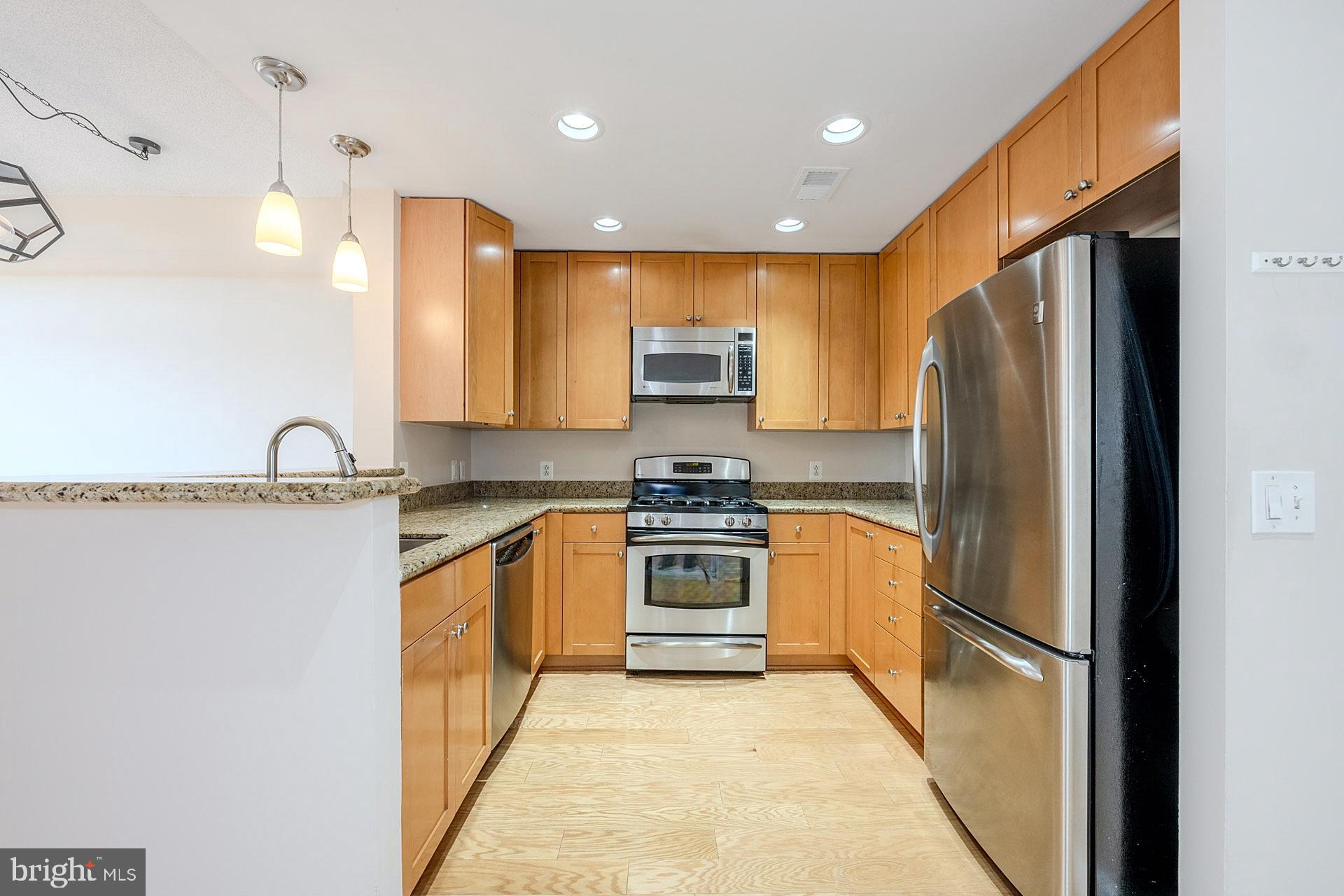 3650 South Glebe Road, Unit 460 Arlington, VA 22202 - Photo 9 of 38 a kitchen with stainless steel appliances granite countertop a refrigerator a sink and a stove