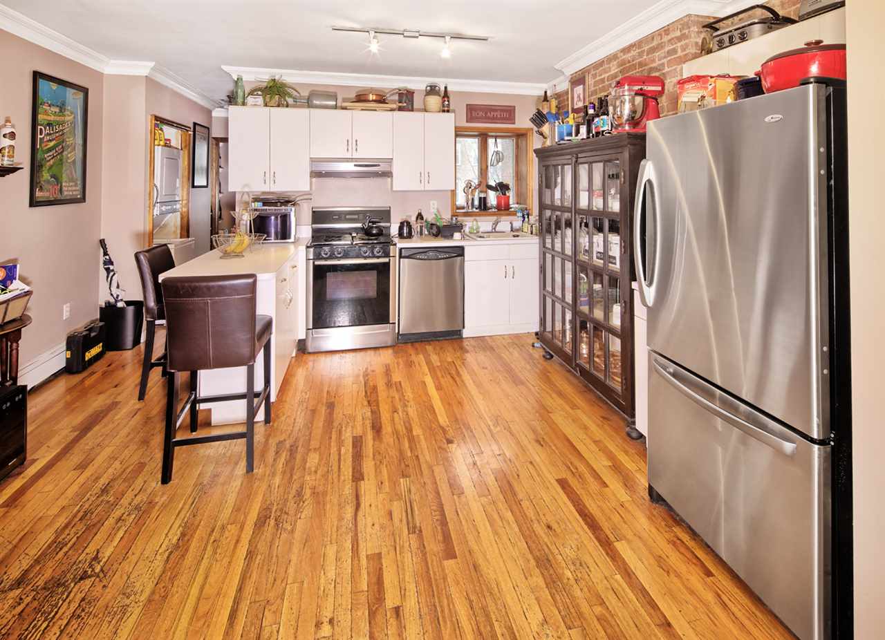 809 Washington Street, Unit 4R Hoboken, NJ 07030 - Photo 1 of 1 a kitchen with stainless steel appliances a refrigerator and wooden floor