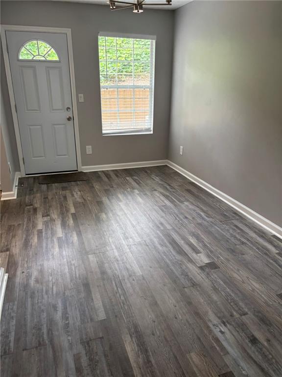 5739 Windfall Lane Lithonia, GA 30058 - Photo 10 of 36 an empty room with wooden floor and windows