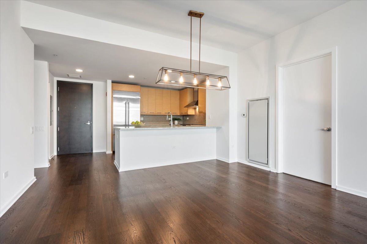 240 East Illinois Street, Unit 2204 Chicago, IL 60611 - Photo 18 of 50 a view of a kitchen with a dishwasher cabinets and wooden floor