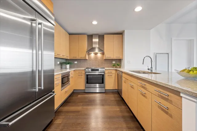 a kitchen with granite countertop white stainless steel appliances and white cabinets