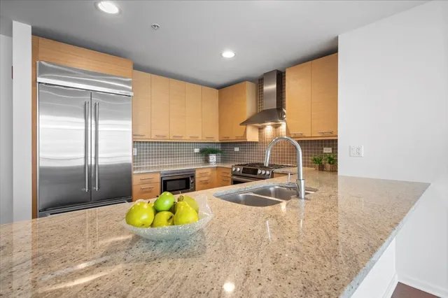 a view of a kitchen with a sink and chandelier