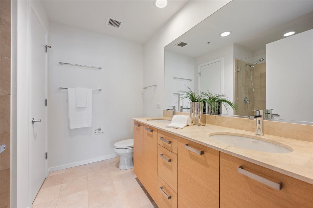 240 East Illinois Street, Unit 2204 Chicago, IL 60611 - Photo 29 of 50 a spacious bathroom with a granite countertop sink a toilet and a shower