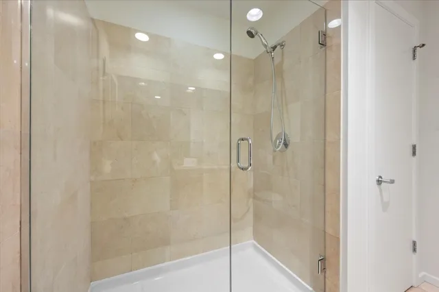 a bathroom with a shower and a glass door