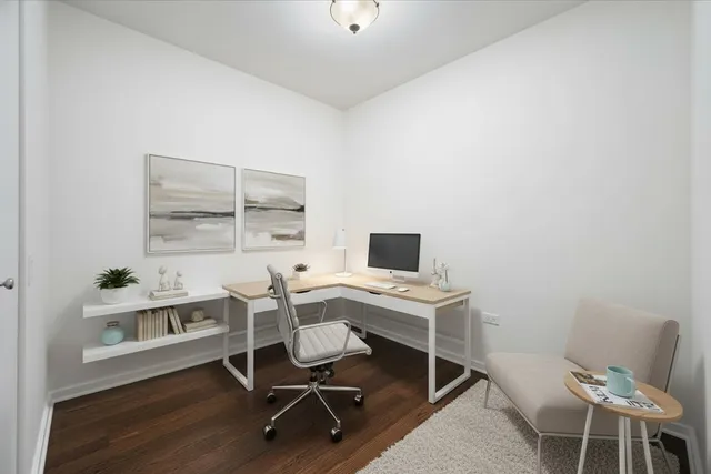 a view of a workspace with furniture and a window