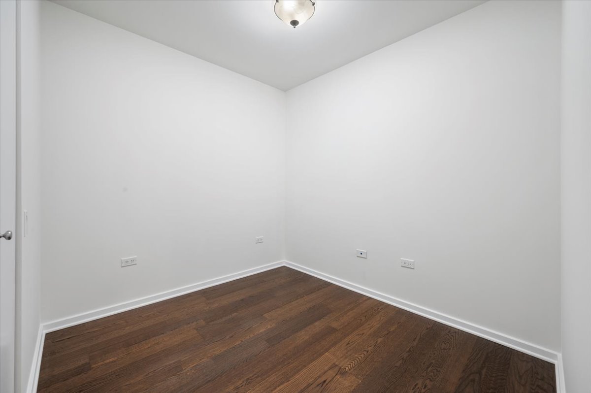 240 East Illinois Street, Unit 2204 Chicago, IL 60611 - Photo 37 of 50 a view of a room with wooden floor and a window