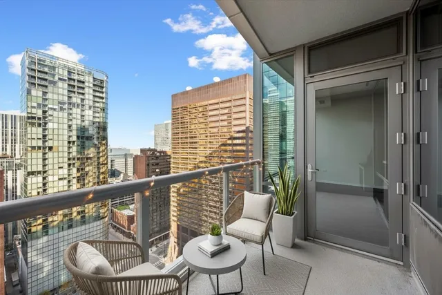 a balcony with table and chairs