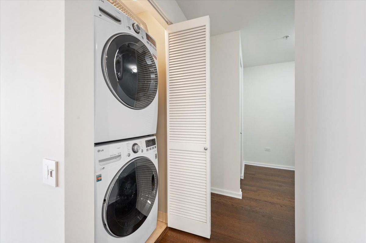 240 East Illinois Street, Unit 2204 Chicago, IL 60611 - Photo 41 of 50 a view of a hallway with washer and dryer