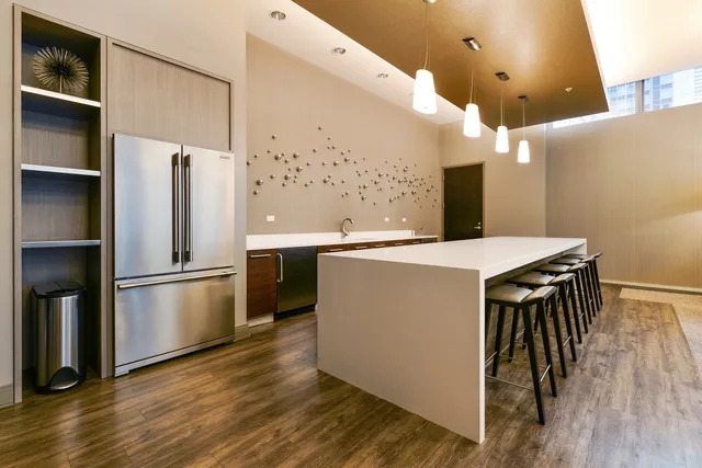 a kitchen with stainless steel appliances a refrigerator and a stove top oven
