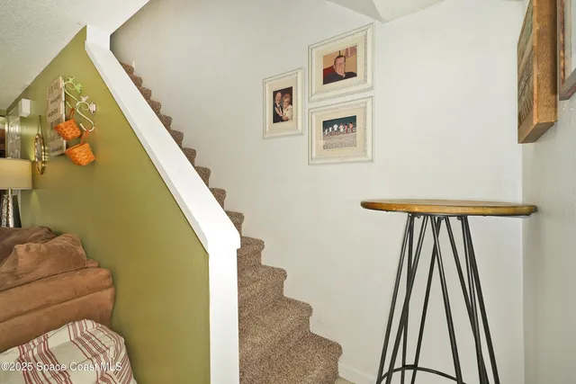 a view of staircase with white walls