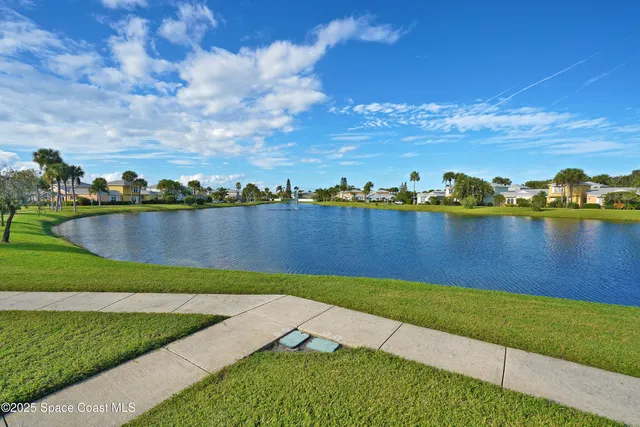 a view of a lake with houses in the back
