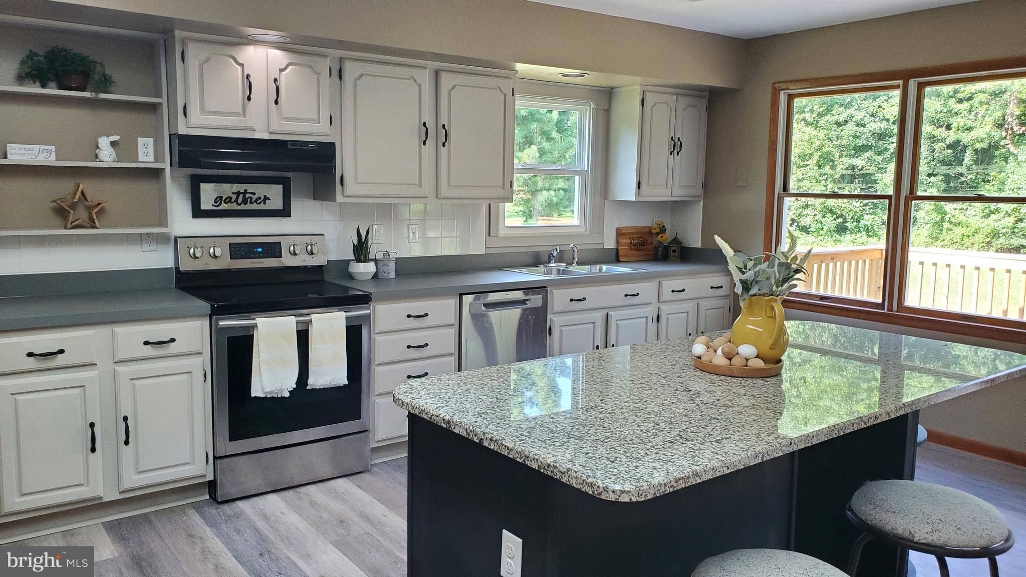 70 Zion Acres Road North East, MD 21901 - Photo 6 of 21 a kitchen with stainless steel appliances granite countertop a stove a sink and white cabinets with wooden floor
