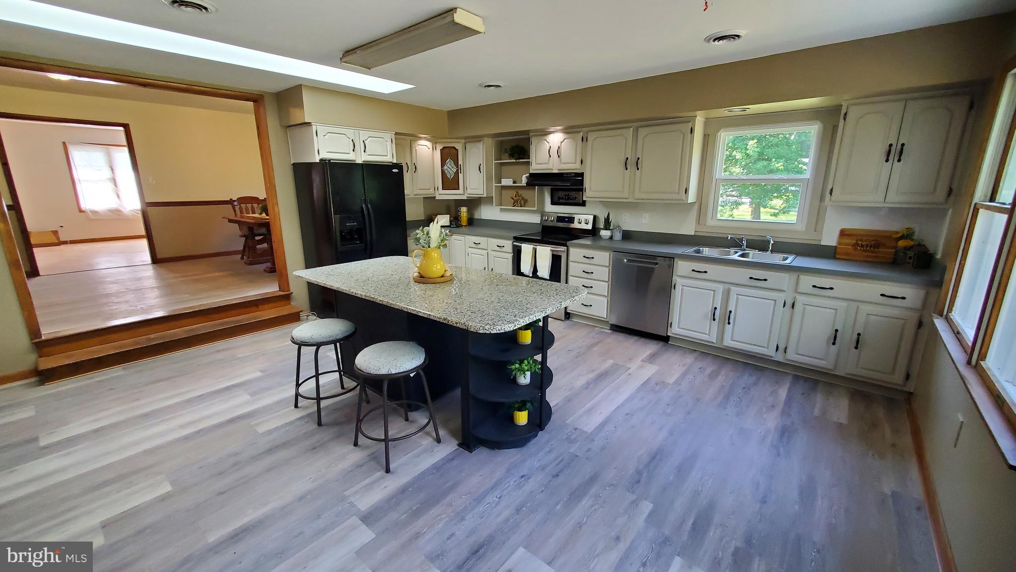 70 Zion Acres Road North East, MD 21901 - Photo 8 of 21 a kitchen with stainless steel appliances granite countertop a refrigerator a stove top oven a sink dishwasher and wooden floor