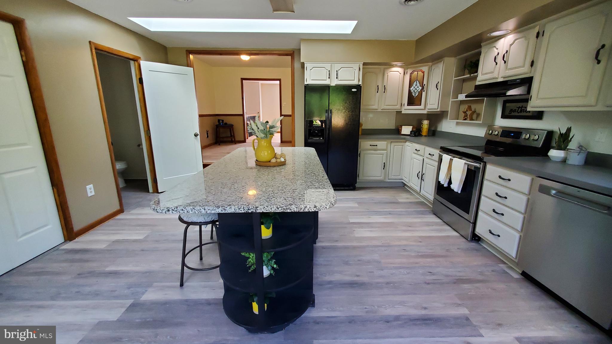 70 Zion Acres Road North East, MD 21901 - Photo 9 of 21 a kitchen with stainless steel appliances granite countertop a refrigerator a stove and a wooden floors
