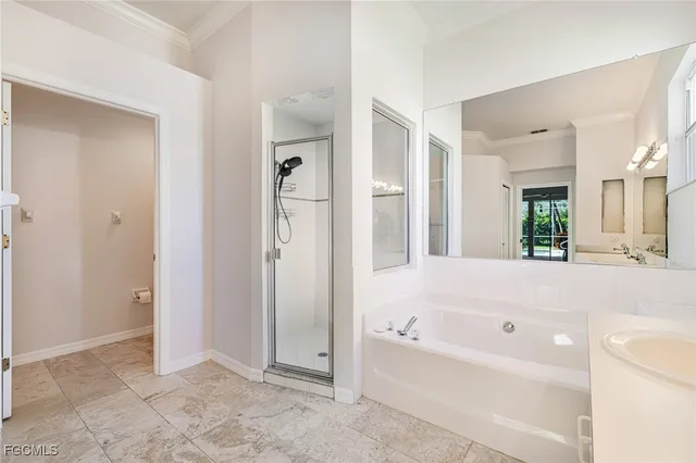 a bathroom with a bathtub shower and a sink