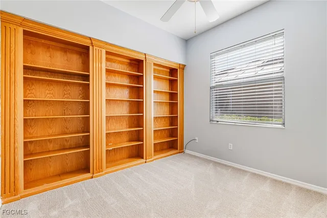 a view of an empty room with a window and closet