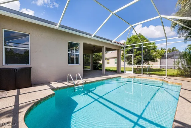 a swimming pool with outdoor seating and yard