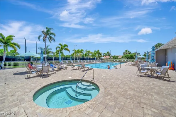 a view of a swimming pool with outdoor seating