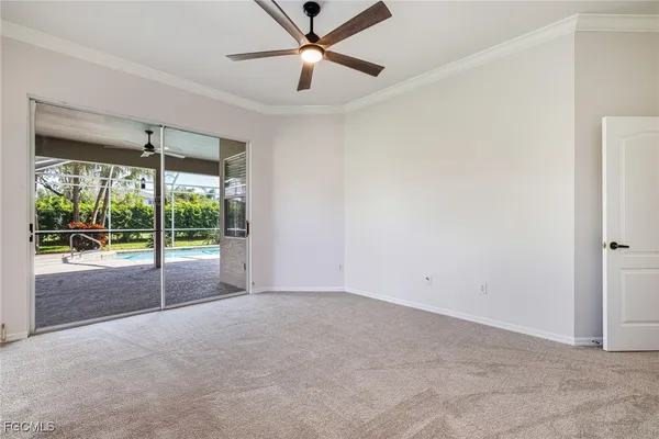 a view of an empty room with a window and a ceiling fan